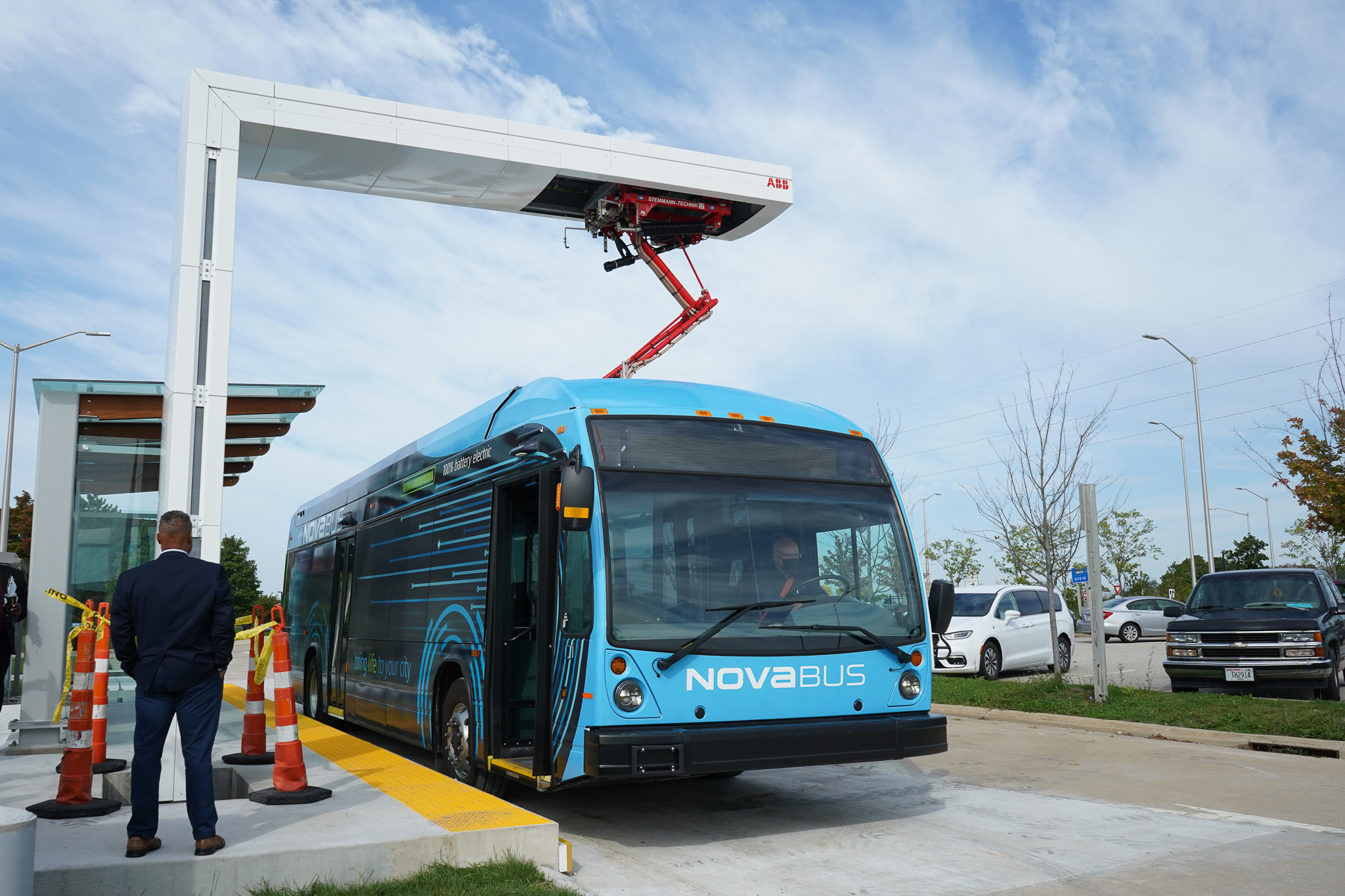 An electric bus connected to an electric bus charger.